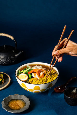 Tablescape of KYUNU Danzai Protein Hand Pulled Noodle soup bowl with condiments