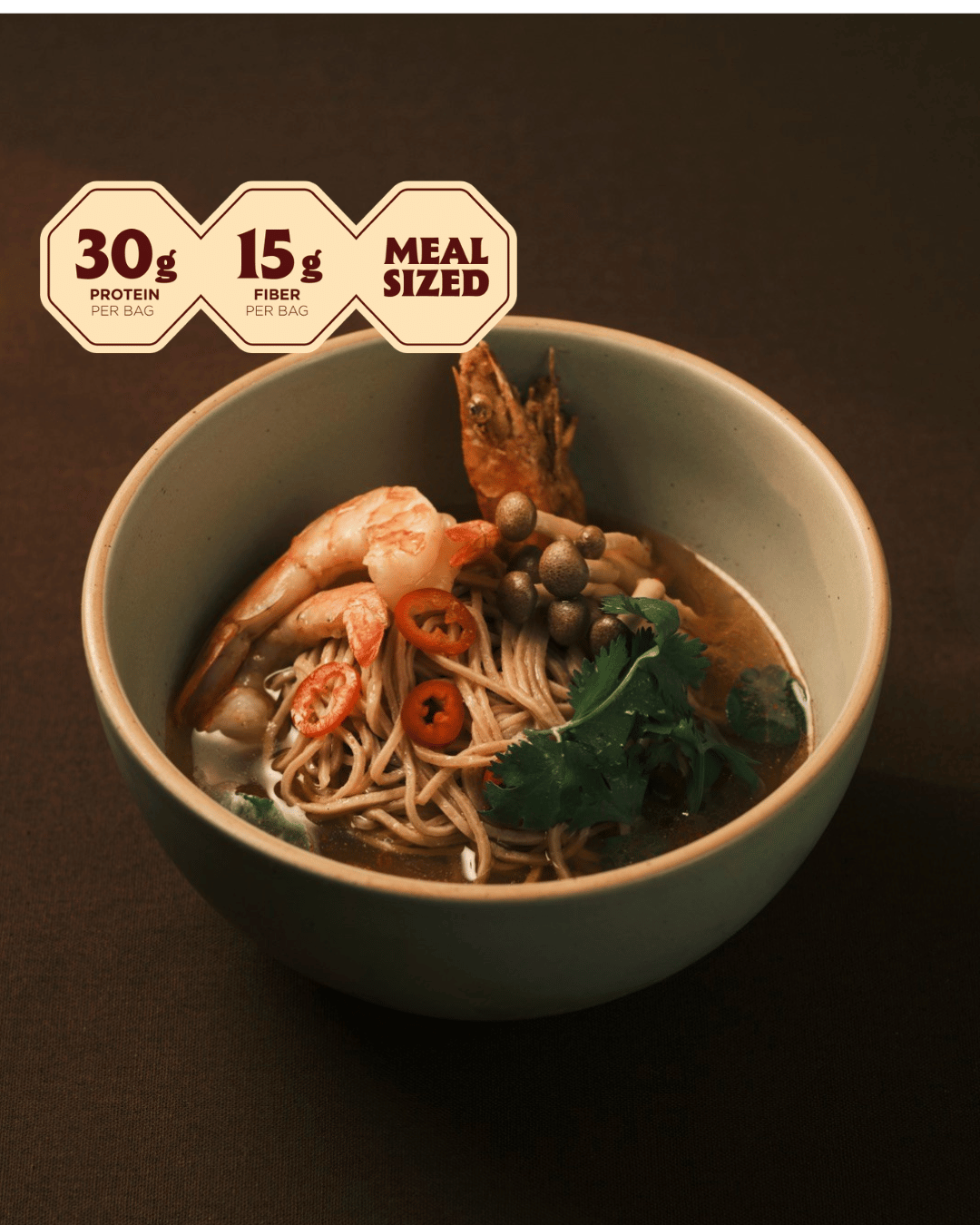 Bowl of Thai shrimp tom yum ramen with shrimp, red chili, mushrooms and cilantro; 30g protein, meal sized